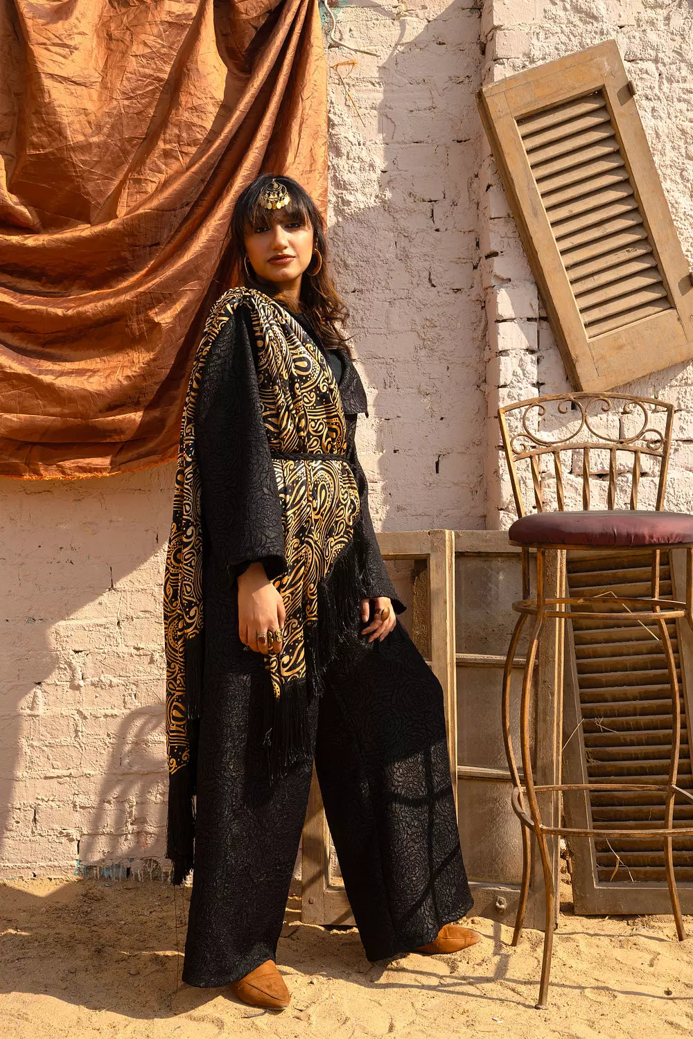 Black jumpsuit with gold shawl