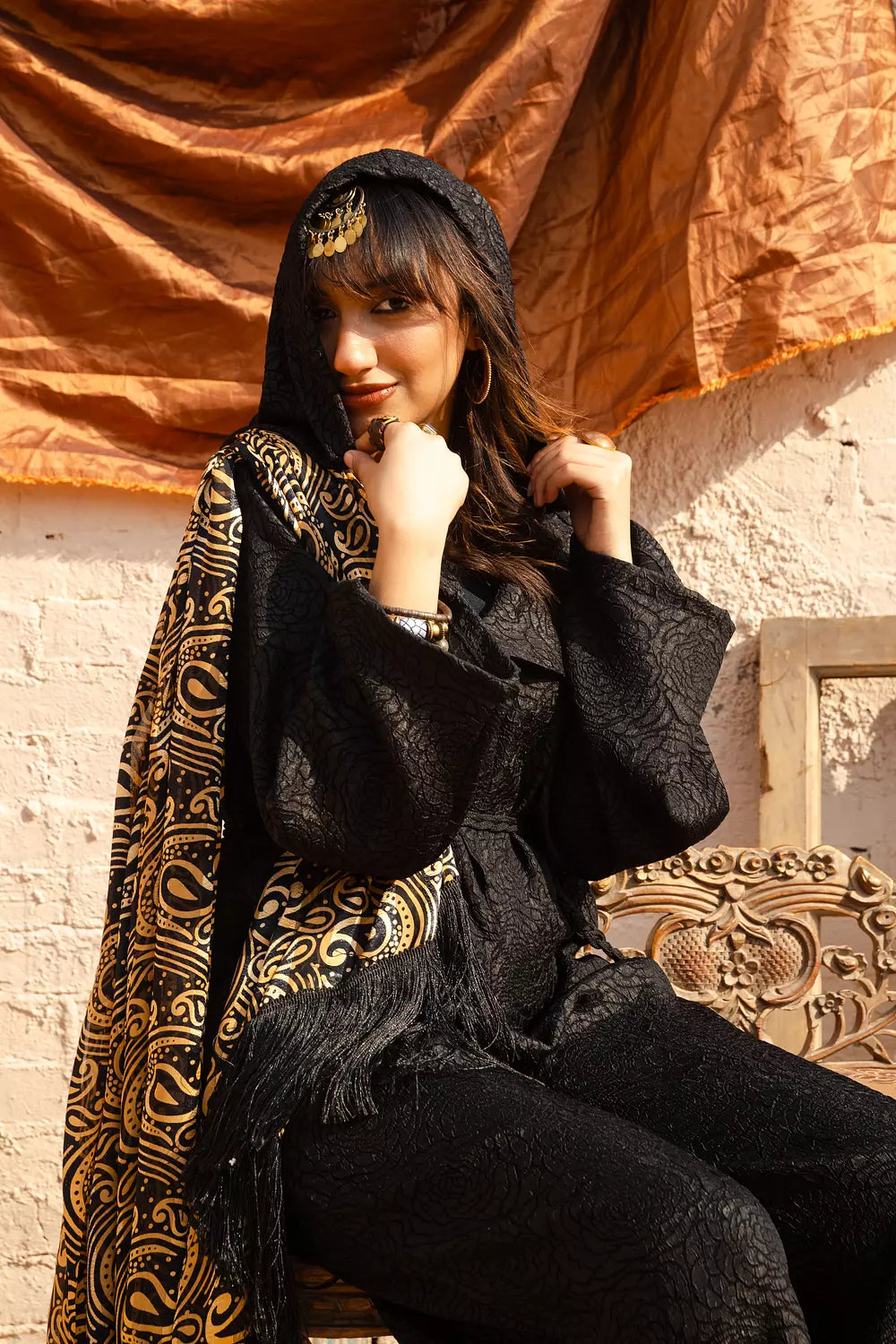 Black jumpsuit with gold shawl